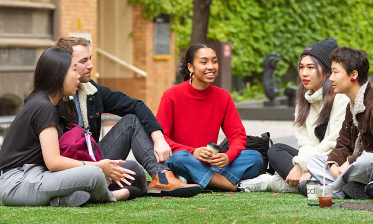 Students sitting on lawn talking